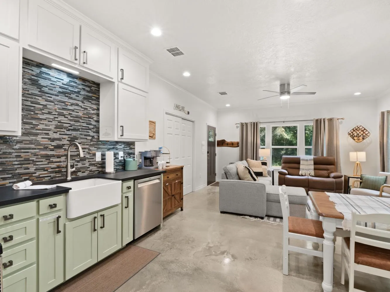 View of kitchen, dining, and living area from the hallway.